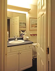 Fluorescent lighting in the bathroom provides uniform, sufficient lighting