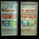 Refrigerated display cases with fluorescent lighting on the left and LED lighting on the right.
