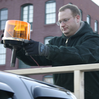 Nick Skinner adjusts an LED beacon light